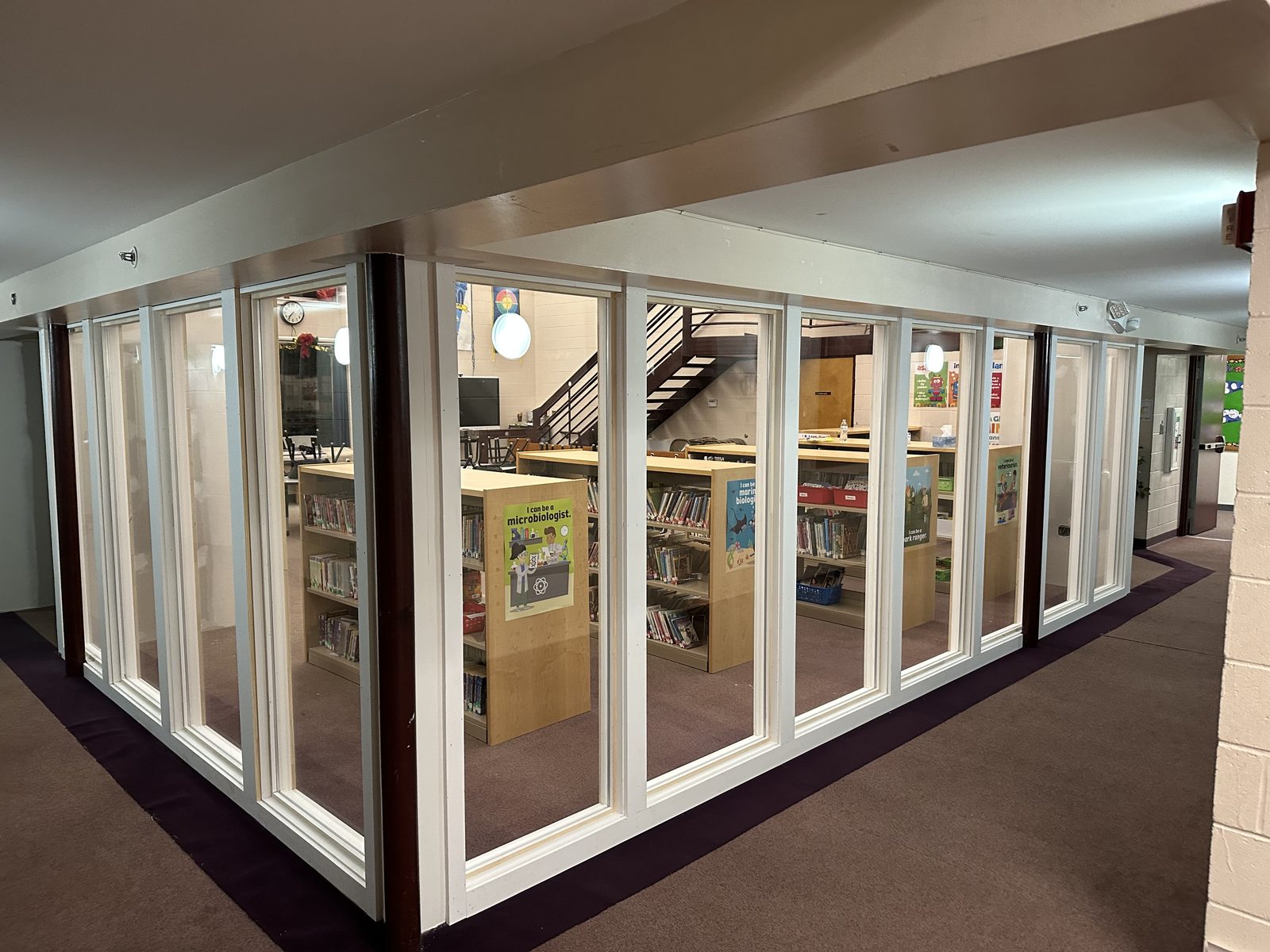 Interior glass wall enclosing a school library