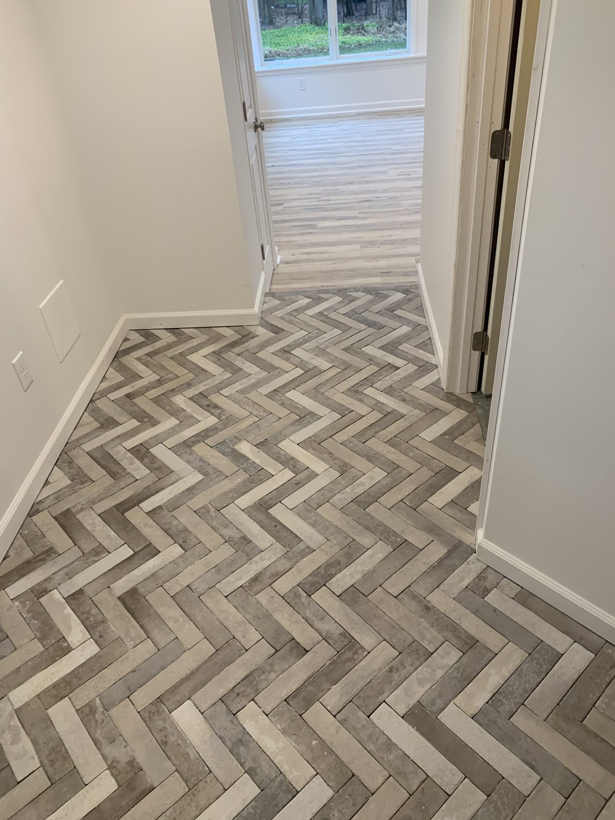 Herringbone brick floor in a finished hallway
