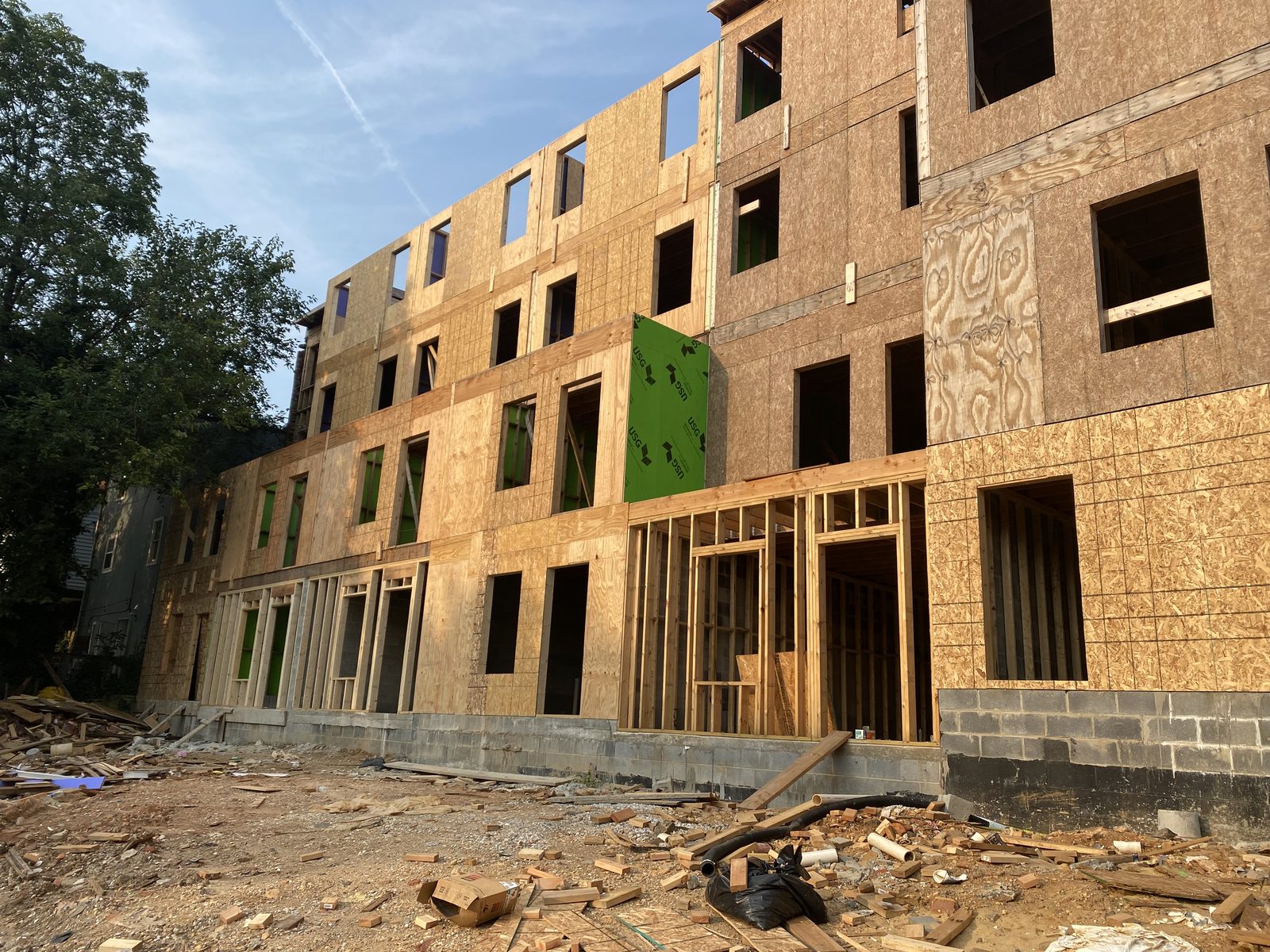 Multi-story house sheathed in OSB during a structural rebuild
