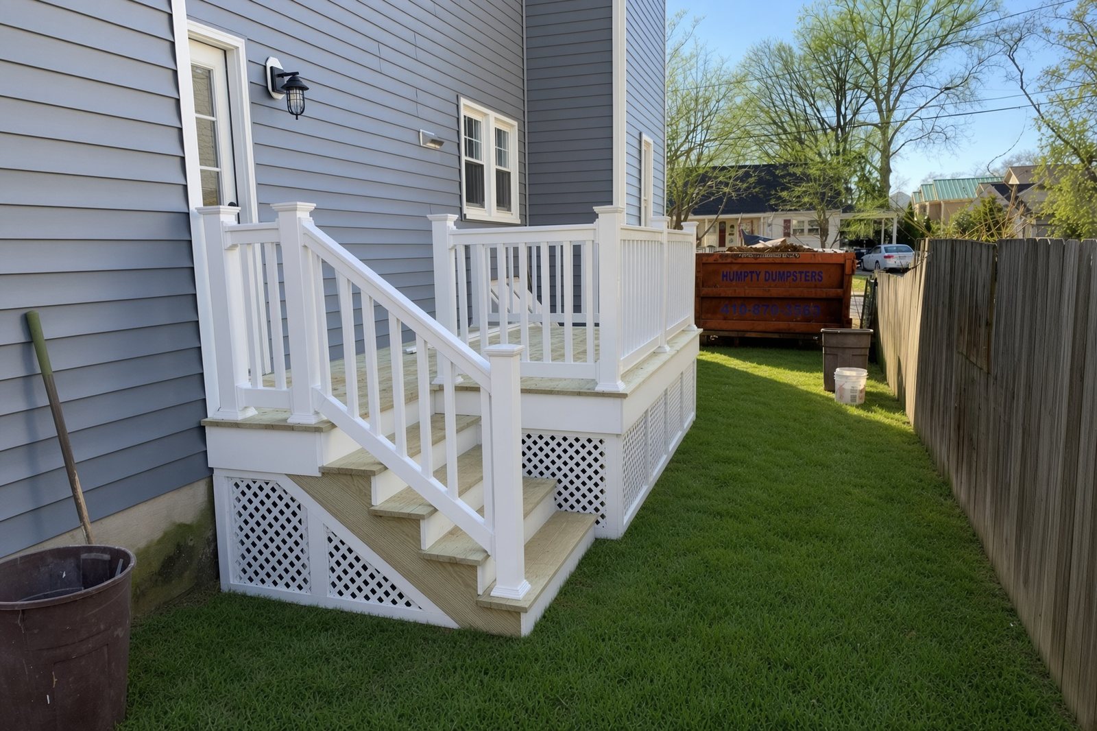 New white railing deck with lattice skirting and pressure-treated treads