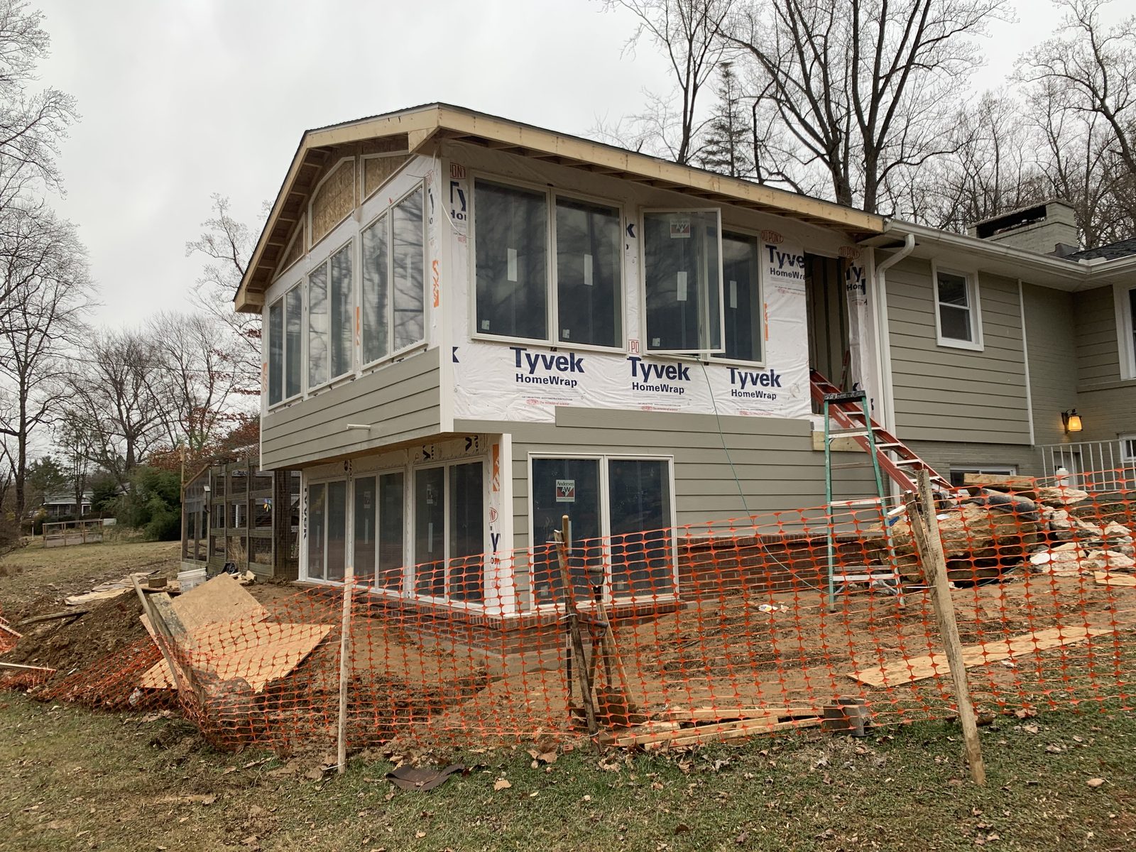 Sunroom addition under housewrap with a full window wall