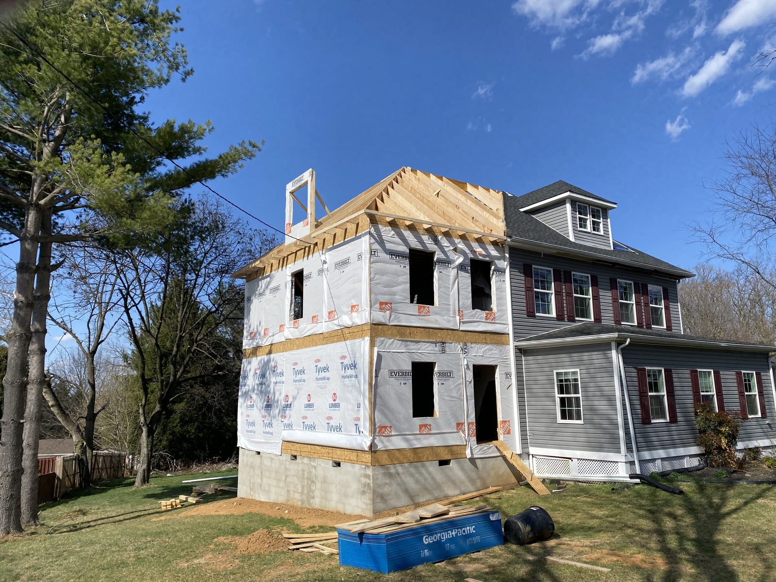 Roof framing going on a two-story addition beside the original house