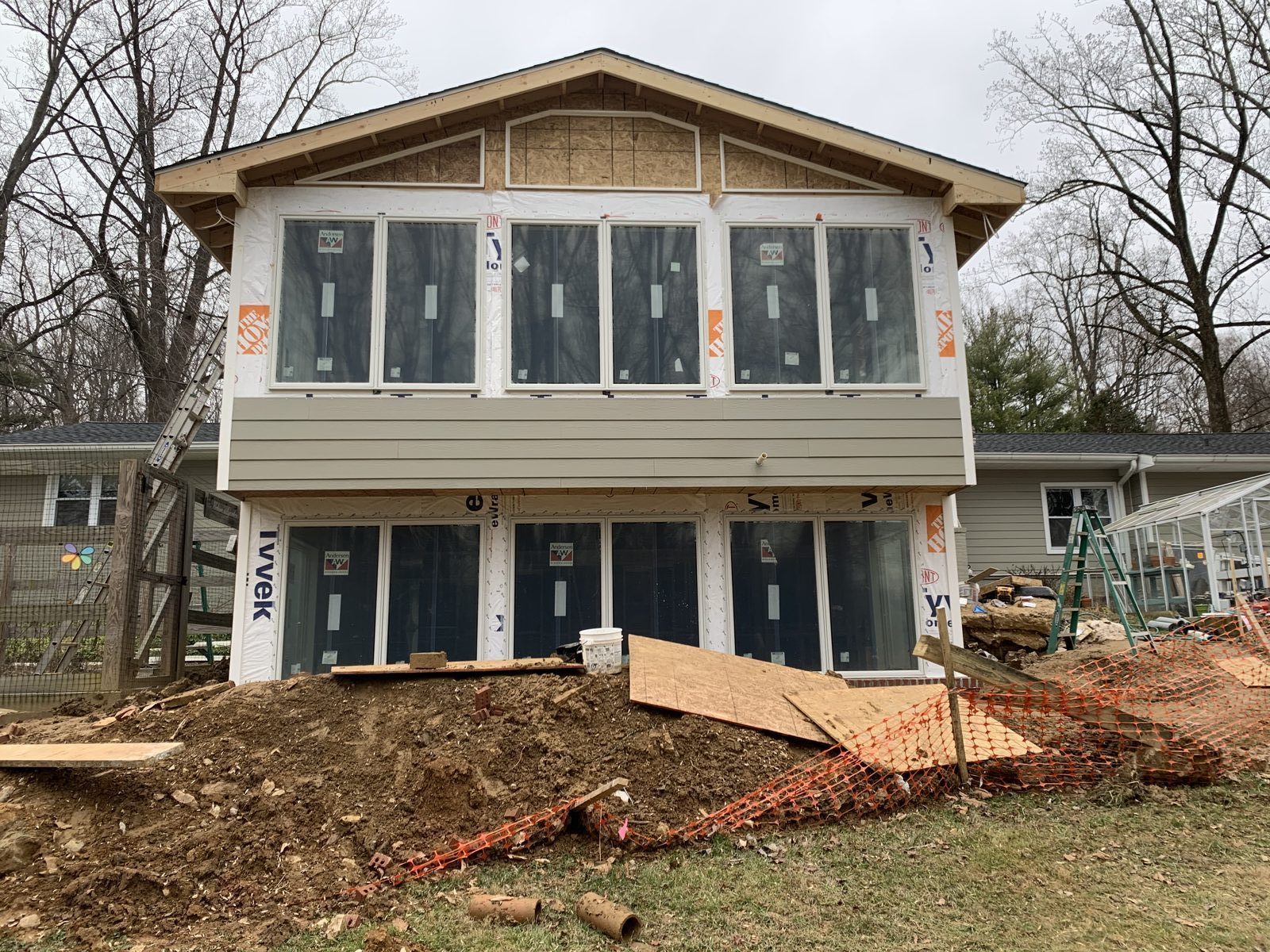 Front of a two-story sunroom with stacked window openings